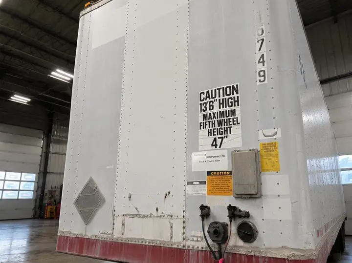 PMF rental trailer front before repair at OG Trailer Repair — weathered, damaged nose panel